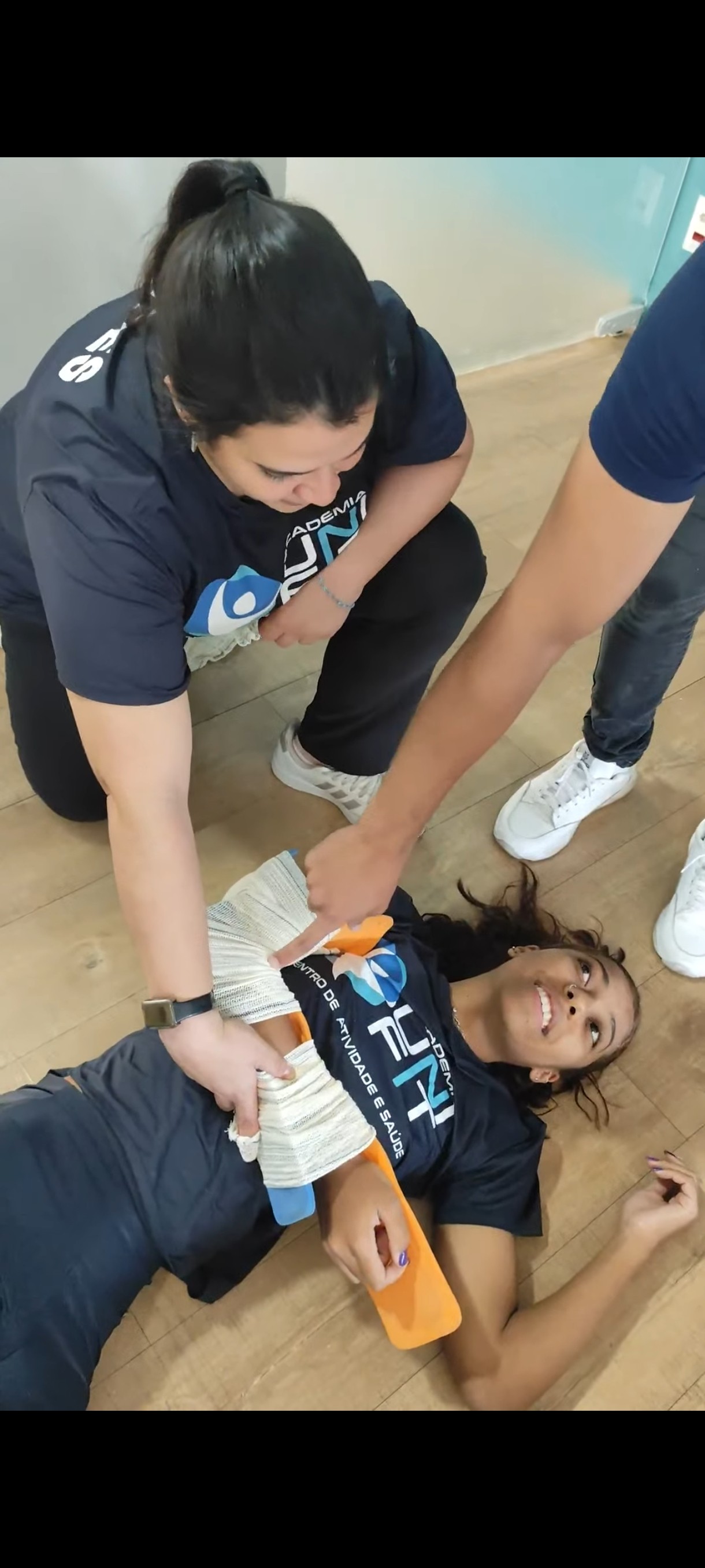 Aluno praticando bandagem e imobilização durante treinamento